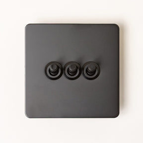 Foundry Series Knurled Toggle Switch and Sockets – Matte Black - Brass bee